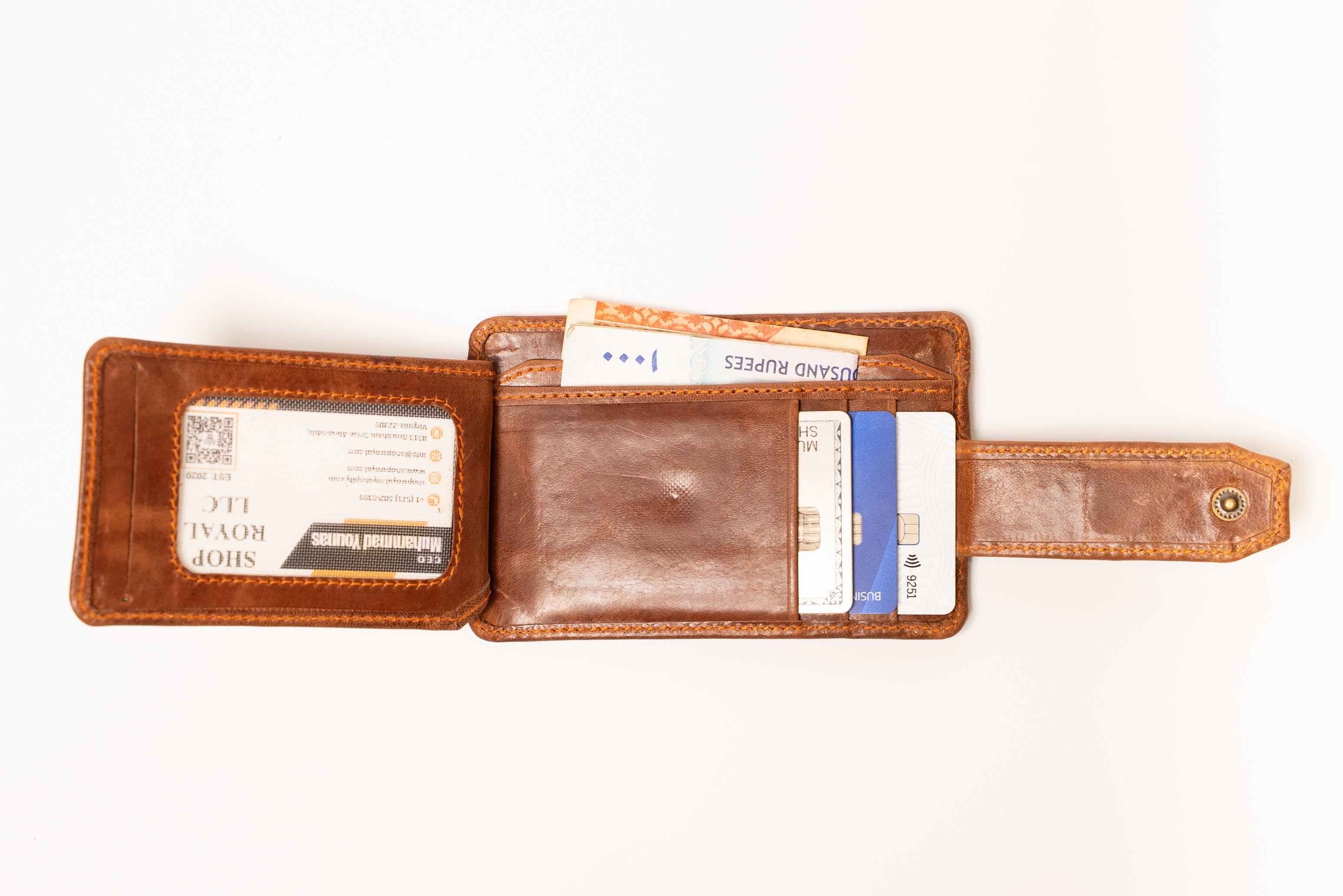 Brown leather wallet with card slots on a white background