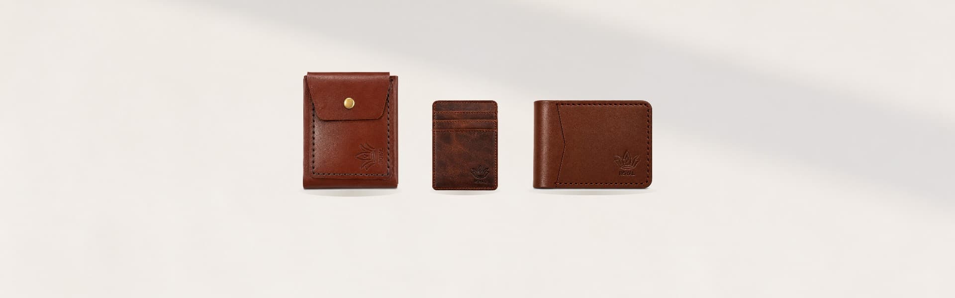 ROYAL slim leather card holders on a pale sand plaster backdrop