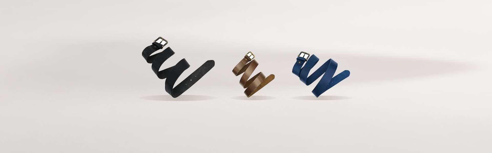 ROYAL hand-crafted leather belts on a warm greige backdrop