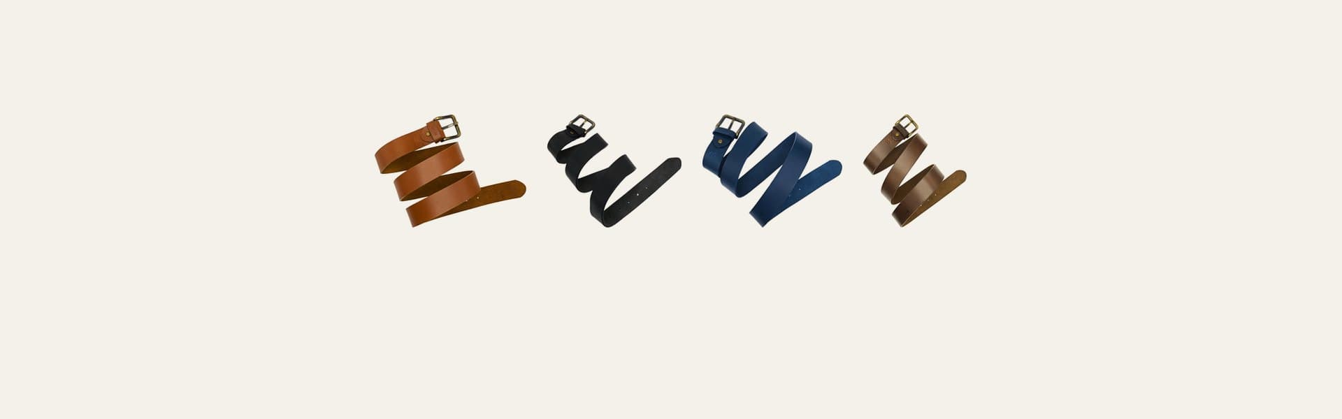 ROYAL hand-crafted leather belts on a warm greige backdrop