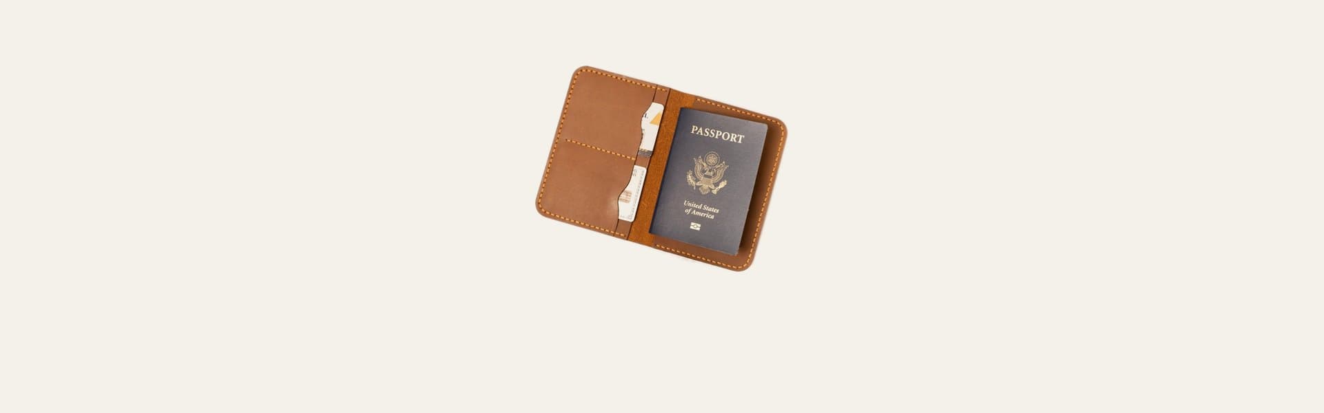 ROYAL leather passport cover in camel, open with a passport