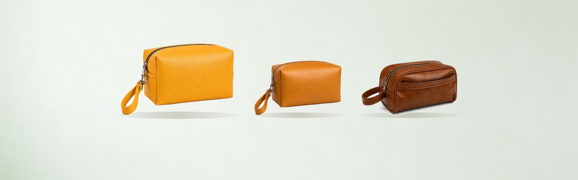 ROYAL leather toiletry bags on a pale sage backdrop
