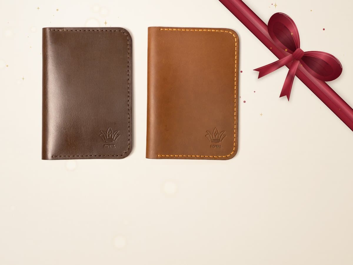 ROYAL leather passport cover on a pale chalk backdrop