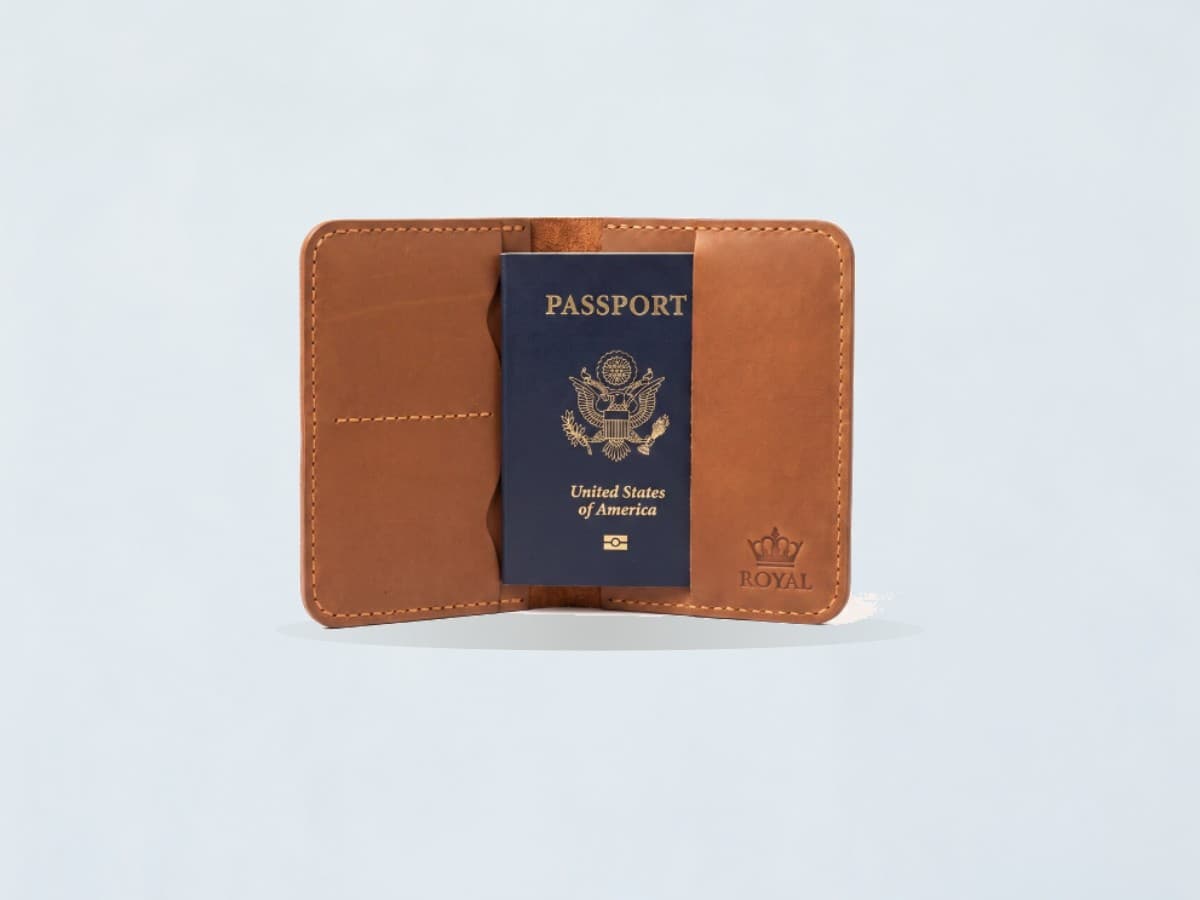 ROYAL leather passport cover on a pale chalk backdrop