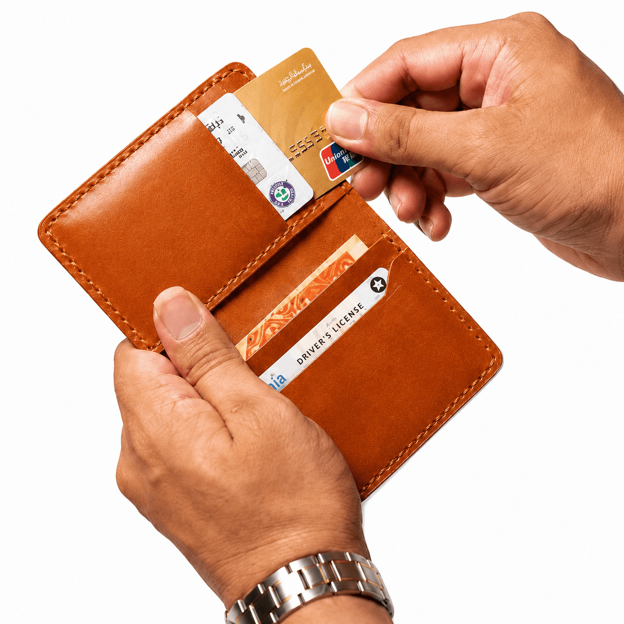 Tan card holder opened in hand, a card being drawn from an interior slot