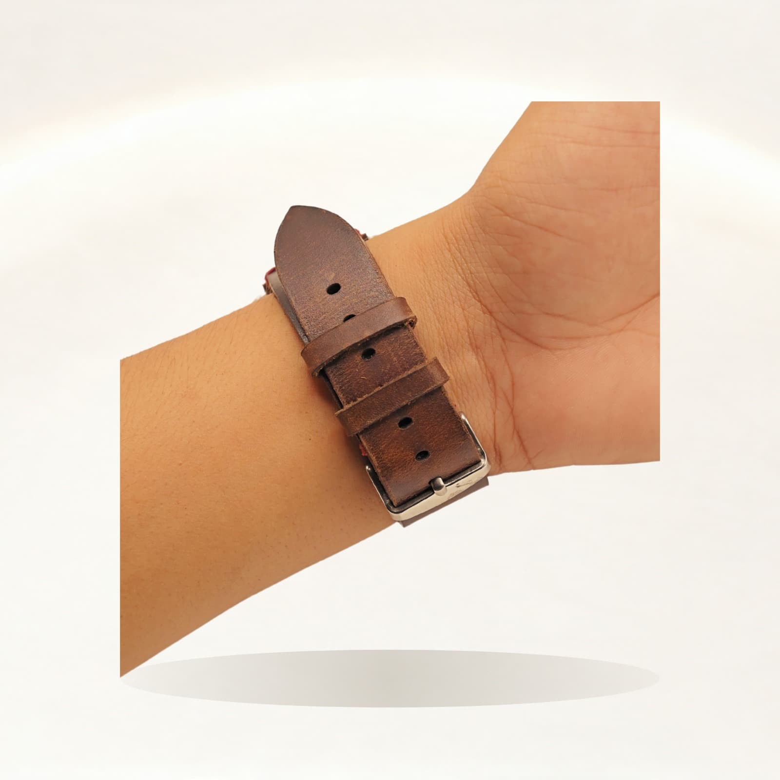 ROYAL Leather Apple Watch Band — Brown, Red Stitch — shown on a soft ivory studio backdrop