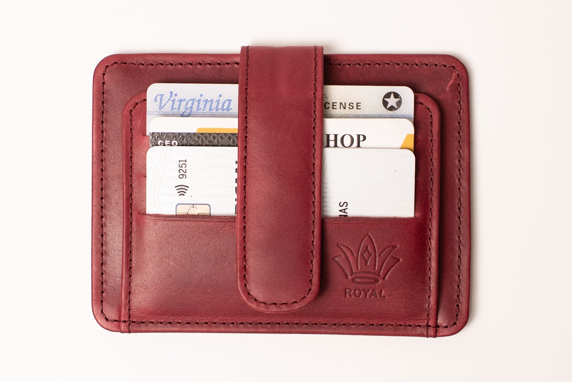 Red leather wallet with cards and a visible brand logo on a white background