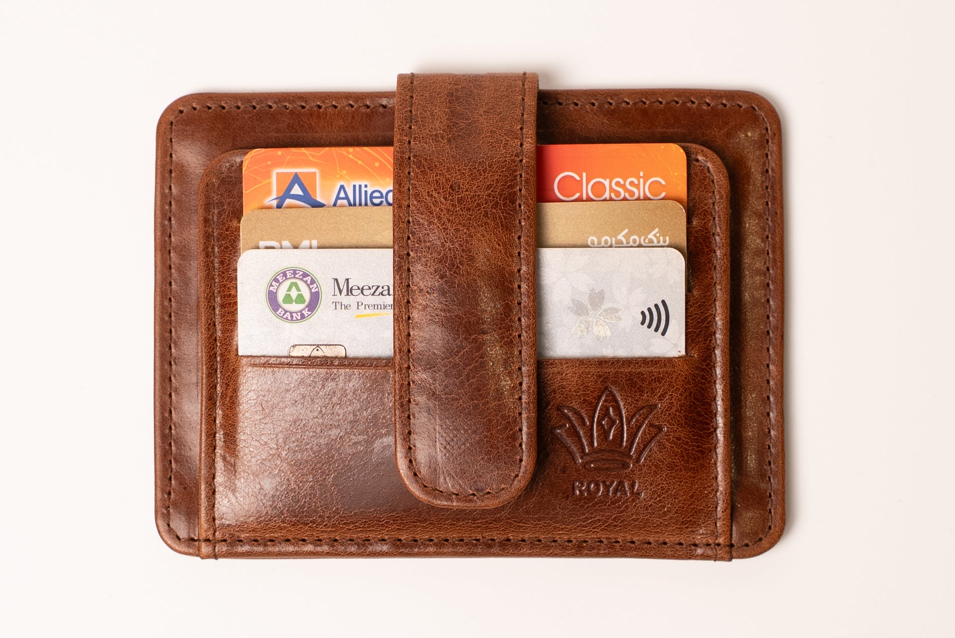 Brown leather wallet with card slots on a white background