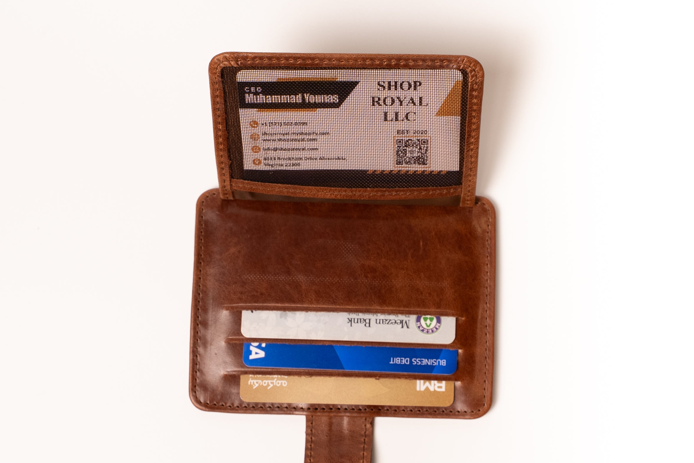 Brown leather wallet with card slots on a white background
