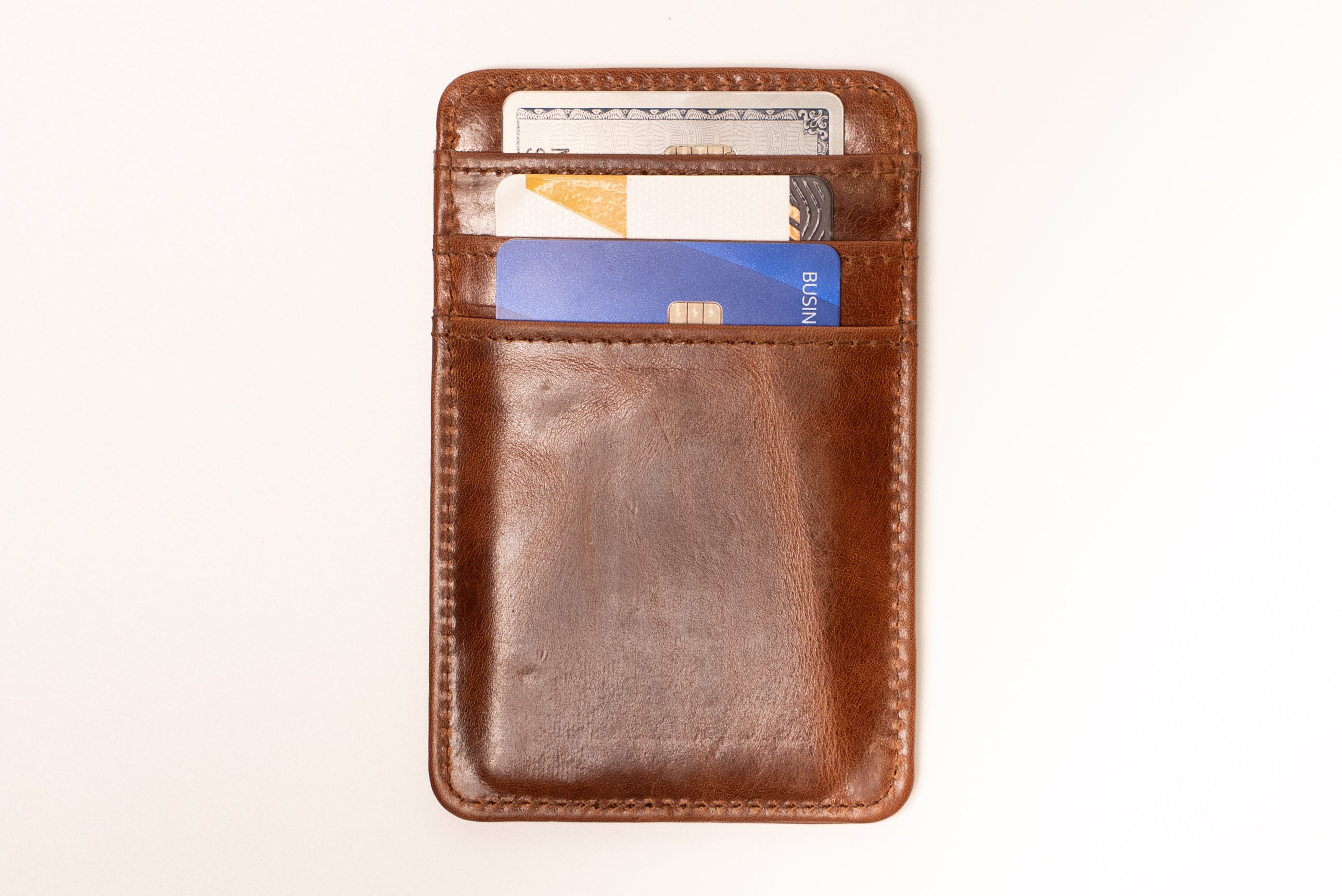Brown leather wallet with cards on a white background